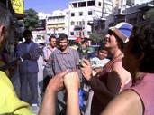  © Photo by Dhyan: Passers by stopping in front of Abu Issa's, Aug 4